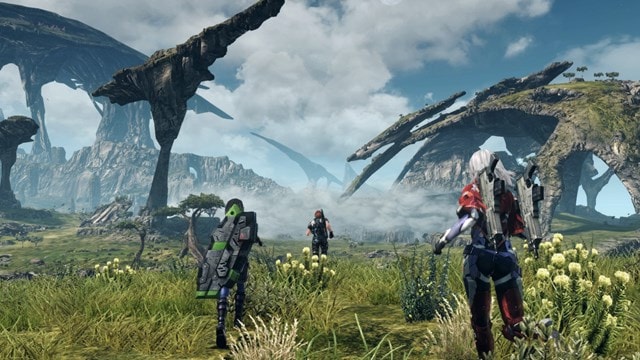 A stunning in-game screenshot from Xenoblade Chronicles X Definitive Edition on Switch, showing characters traversing the vast alien landscapes of Mira.