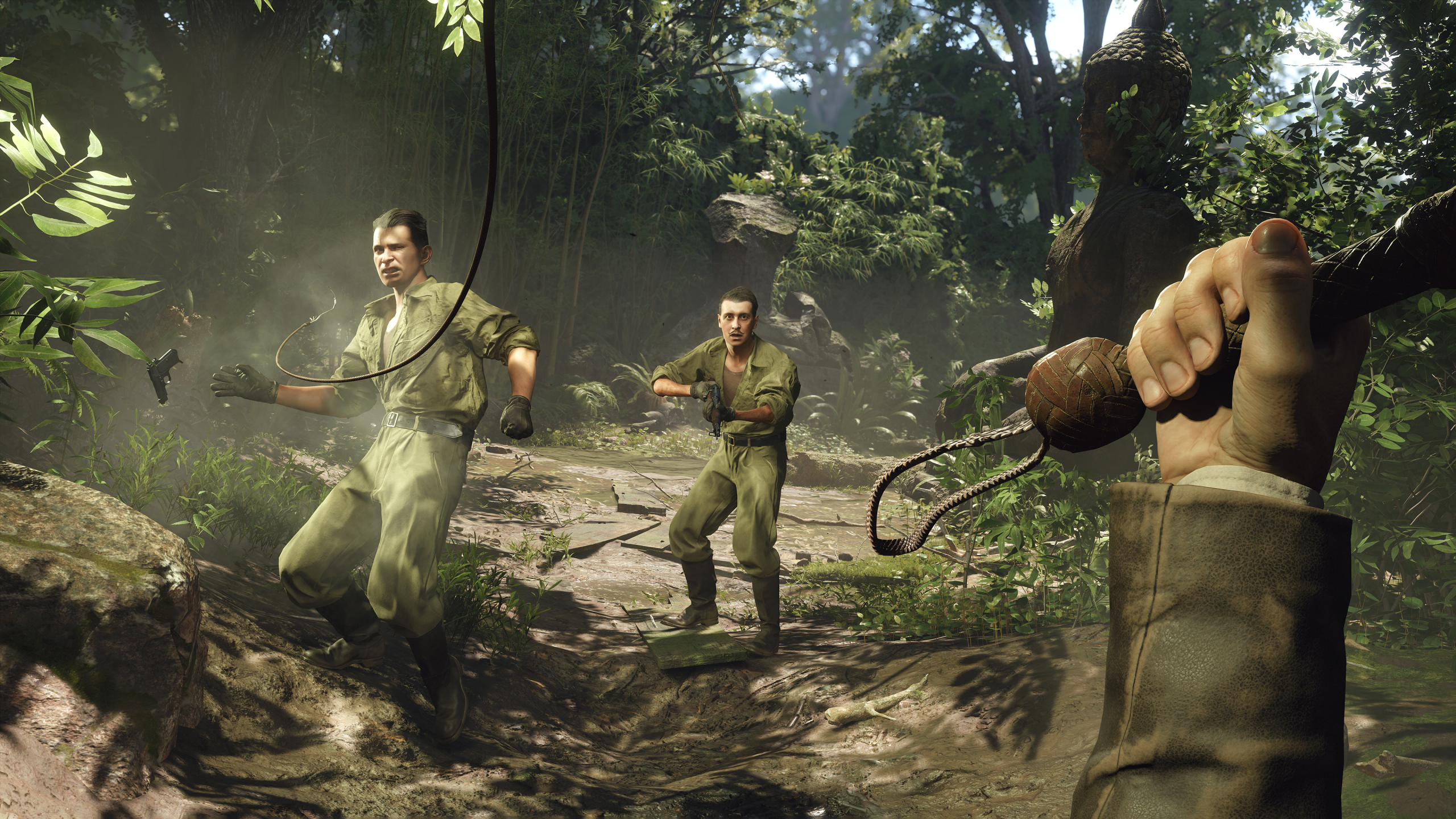 First-person view of Indiana Jones using a whip to disarm enemies in a jungle during combat in Indiana Jones and the Great Circle.