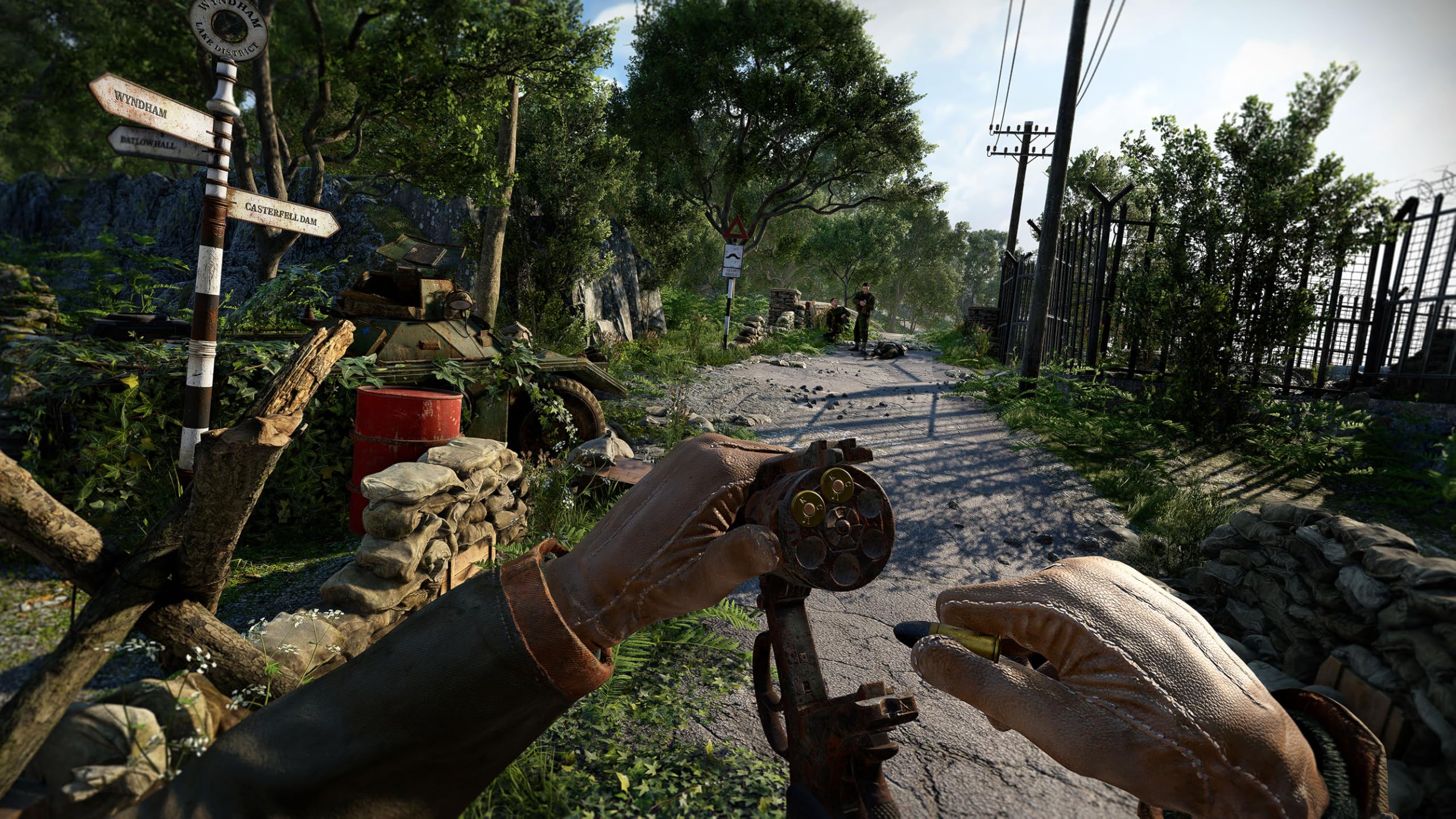 A survivor reloads a revolver at a fortified checkpoint in Atomfall, surrounded by overgrown paths, sandbags, and British road signs.