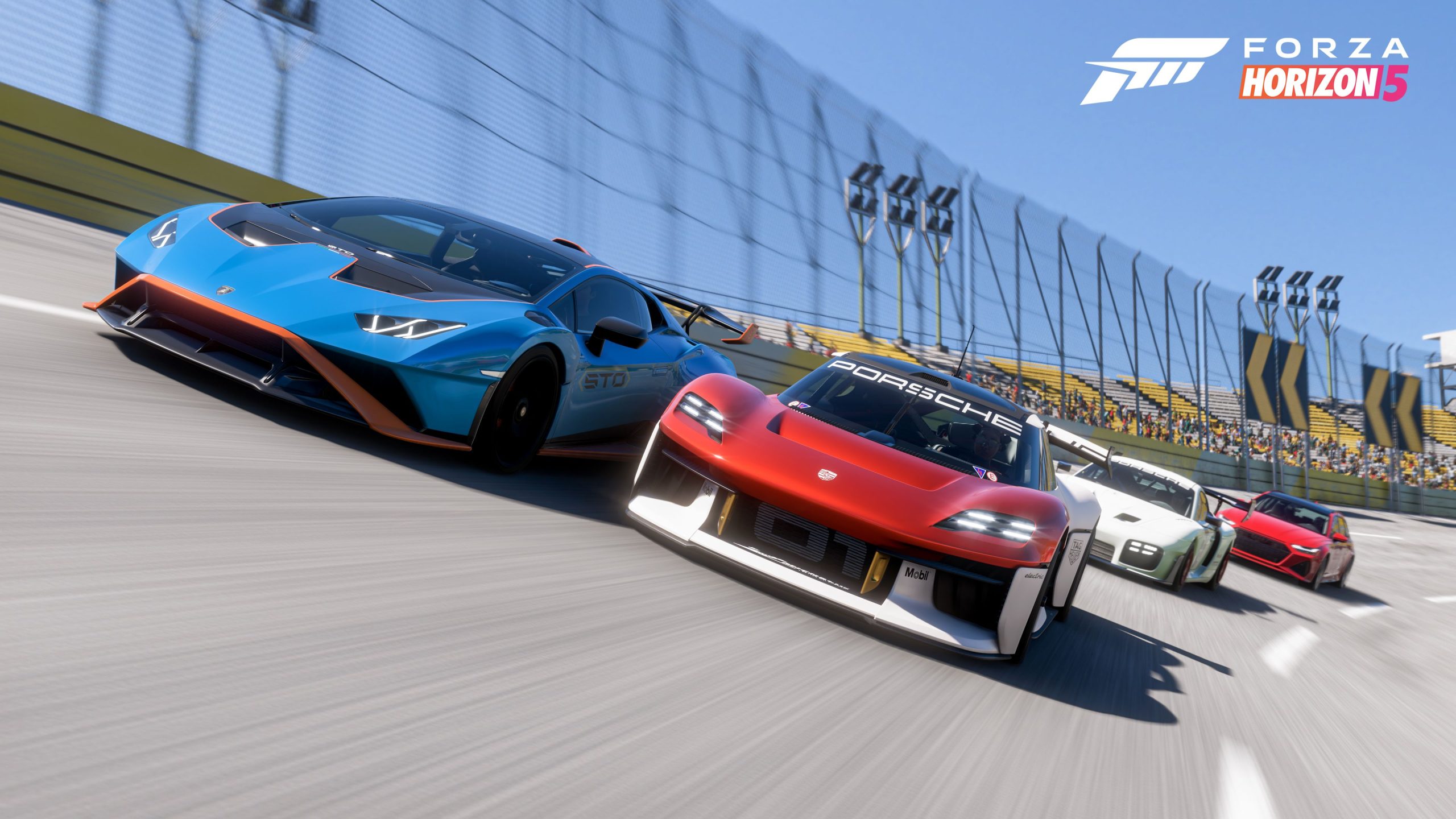 Front-facing shot of Porsche and Lamborghini supercars racing neck and neck on a stadium track in Forza Horizon 5