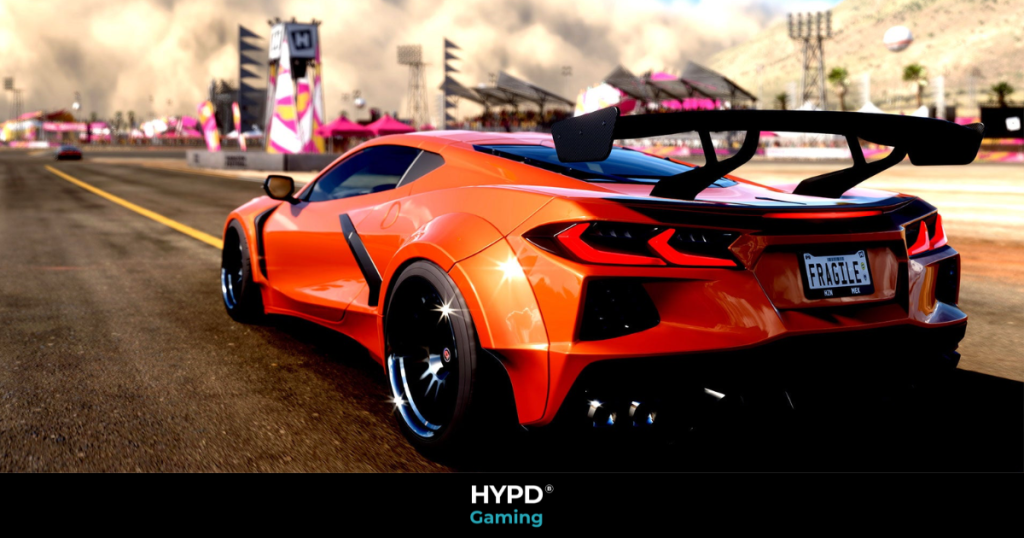 Orange supercar with rear spoiler racing through a Forza Horizon 5 festival track on PlayStation 5