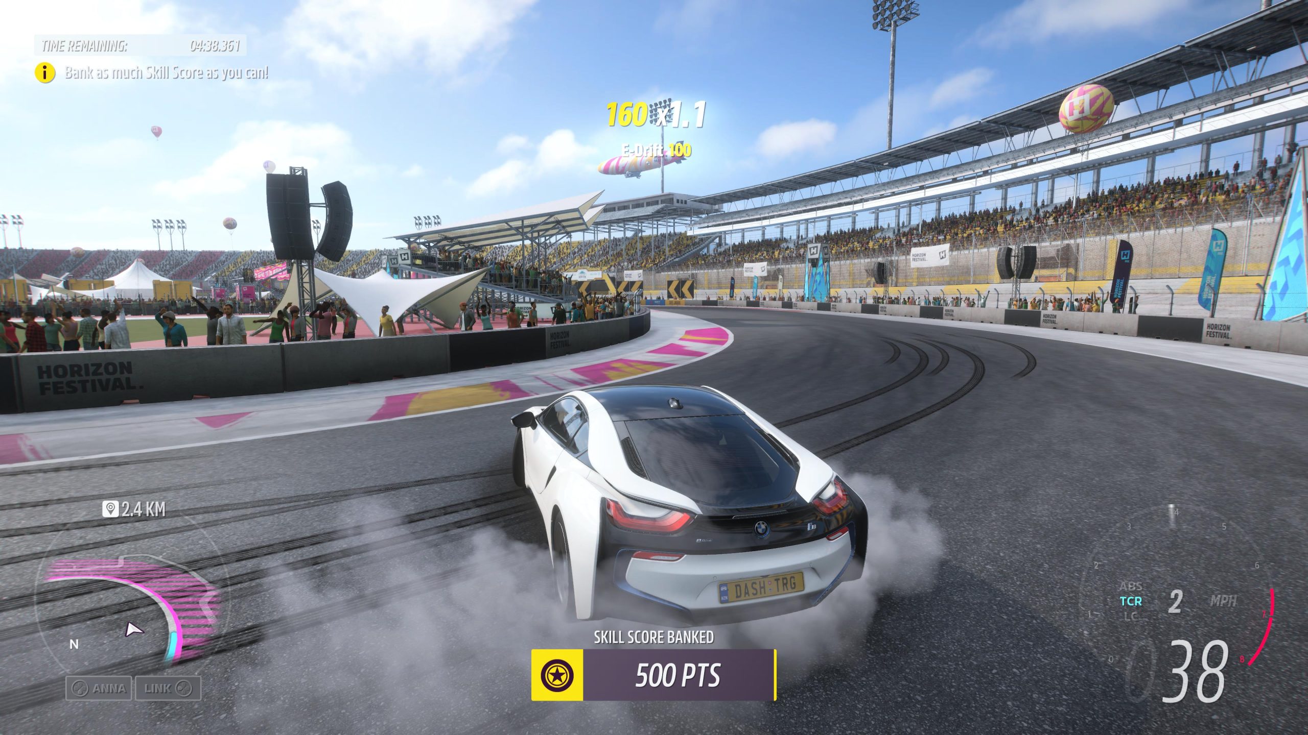 White BMW i8 drifting around a corner at Horizon Festival stadium in Forza Horizon 5, kicking up tyre smoke