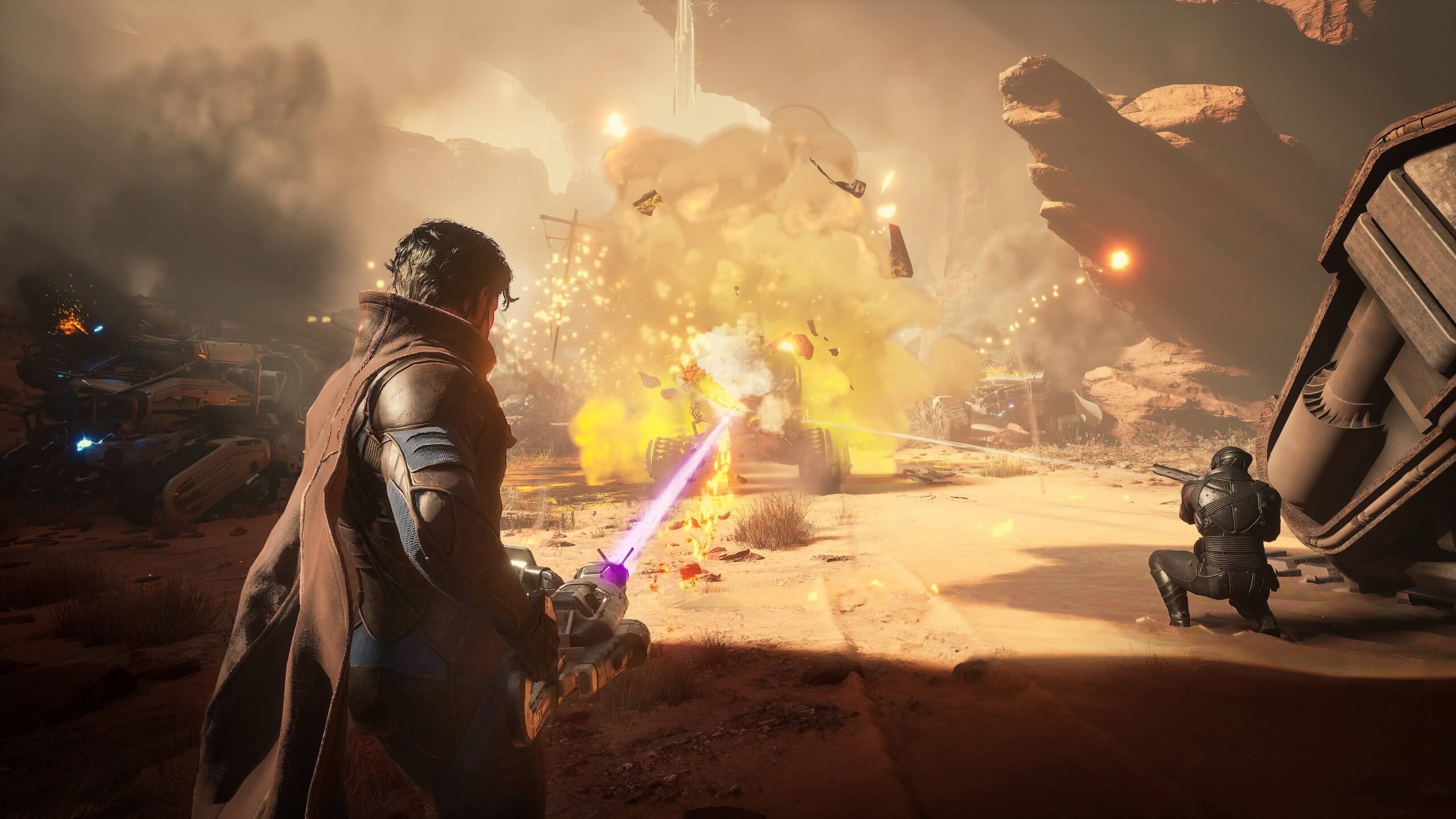 A player unleashes a purple energy blast during a heated battle as explosions erupt in Dune: Awakening’s desert canyon battlefield