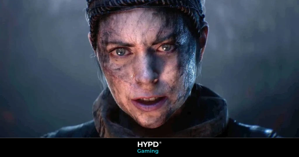 Intense close-up of Senua’s face in Hellblade II, showing dirt, scars, and emotion in a cinematic moment