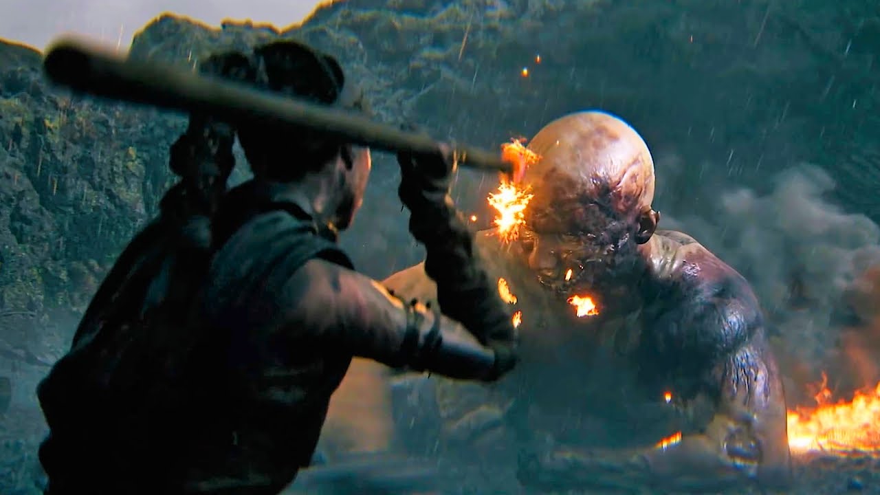 Senua strikes a fiery blow against a towering giant in Hellblade II during an intense cinematic combat sequence