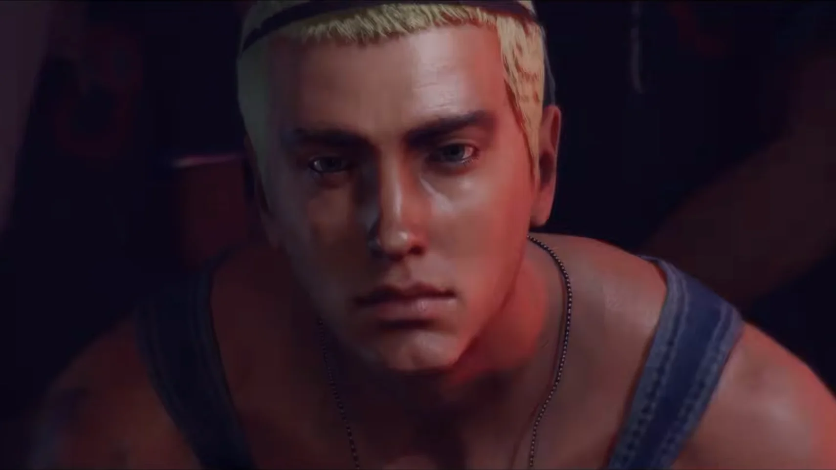 Gaming World News: Close-up cinematic render of a male character with short blond hair and intense lighting, featured in Hitman: World of Assassination’s Elusive Target mission.