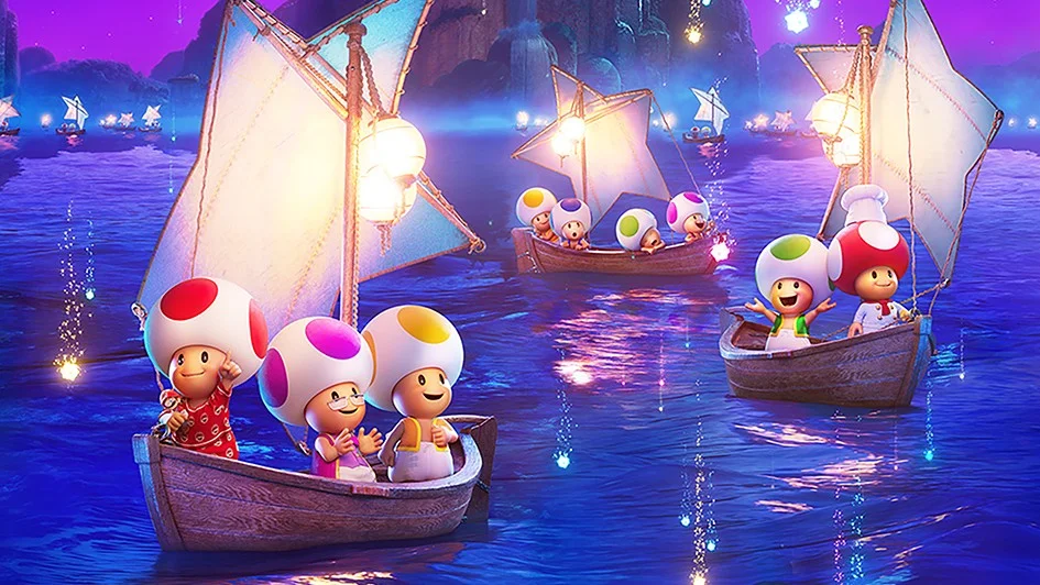 Colourful Toad characters sailing in wooden boats under a starry night sky, promoting the upcoming Super Mario Galaxy Movie.