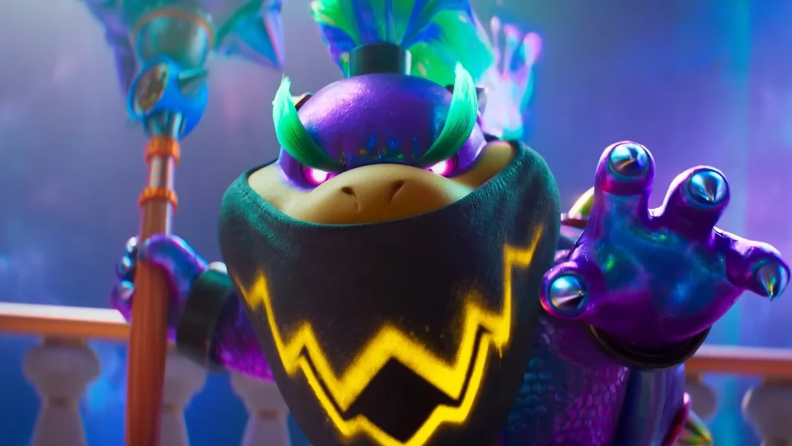 Bowser Jr. wearing a mask and holding a paintbrush in a vibrant Super Mario Galaxy movie scene, reaching forward with glowing eyes and colourful effects