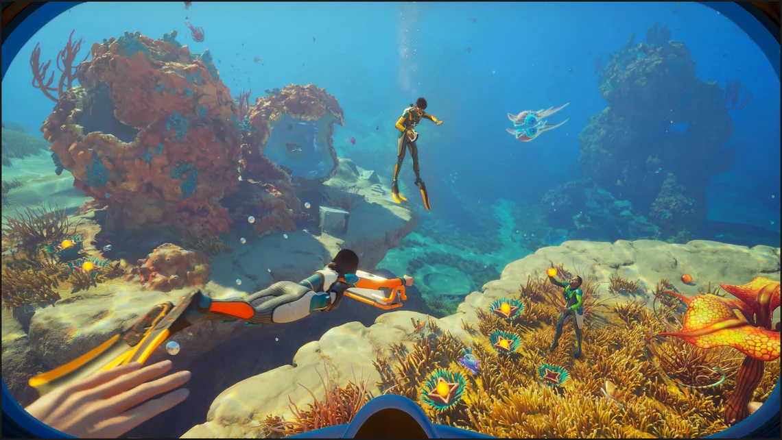 Underwater gameplay scene from Subnautica 2 showing divers exploring a vibrant alien ocean filled with coral reefs and sea creatures.