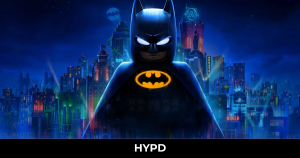 LEGO Batman standing before the illuminated Gotham City skyline in Lego Batman: Legacy of the Dark Knight, showcasing the Dark Knight in a dramatic night-time setting.