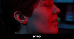 Silent Hill: Townfall character illuminated by an intense red light in a dark and atmospheric scene.