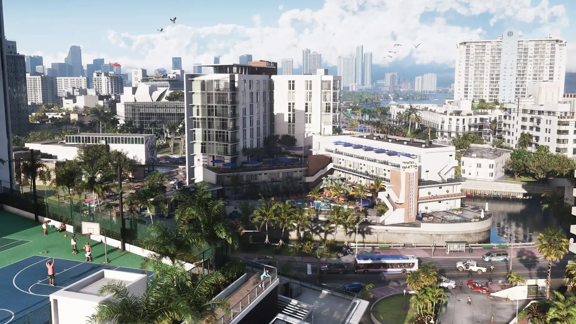 GTA 6 screenshot showing Vice City's Miami-inspired skyline, waterfront hotels, palm-lined streets, basketball courts and busy roads in Rockstar's open world.